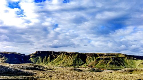 Scenic view of landscape against cloudy sky