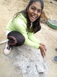 Portrait of smiling woman sitting outdoors