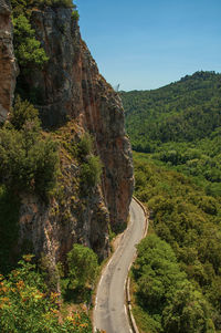 View of green valley and cliff, cut by road, near chateaudouble, in the french provence.