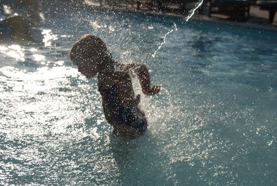 Side view of girl enjoying in swimming pool