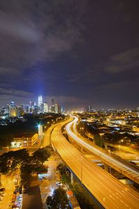 High angle view of illuminated cityscape against sky at night