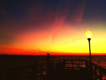 Street light against sky at sunset