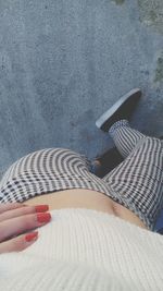 Close-up of woman standing on tiled floor