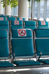 Close-up of blue seats in row outdoors