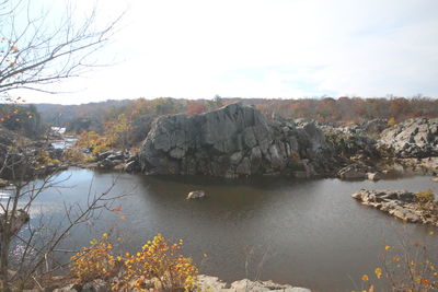 Scenic view of lake by trees against sky