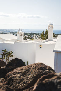 White building by sea against sky