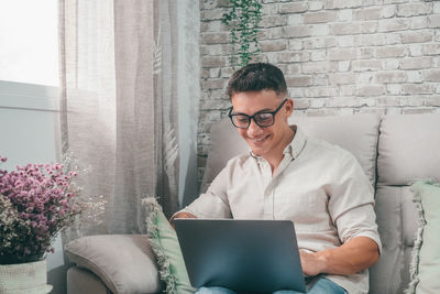 Businesswoman using laptop while sitting at home