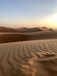 Scenic view of desert against sky during sunset