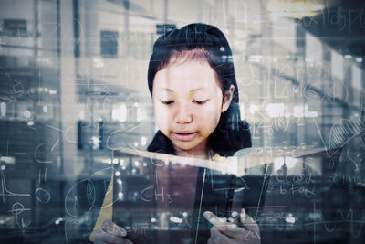 Portrait of woman touching glass window