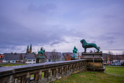 Statue of building against cloudy sky