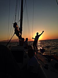 Boats in sea at sunset