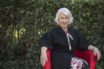 Helen mirren in rome for movie whinchester's widow standing against plants