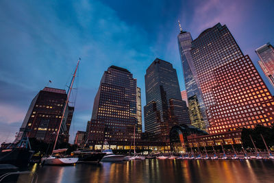 Illuminated buildings in city against sky