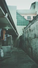 Empty alley amidst buildings against sky