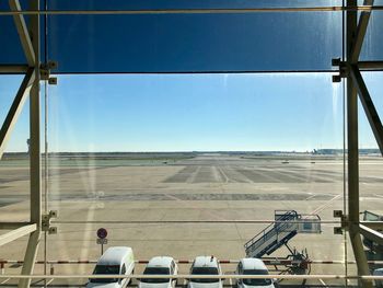 Airplane on airport runway against clear blue sky