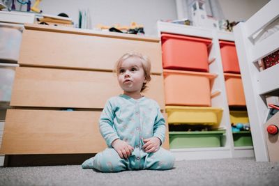 Cute baby girl sitting on floor