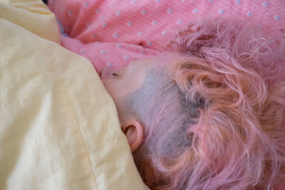 Close-up of baby sleeping on bed