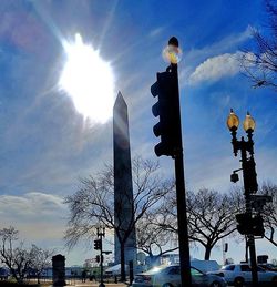 Low angle view of sun shining through trees