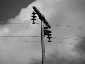 Low angle view of electricity pylon against sky