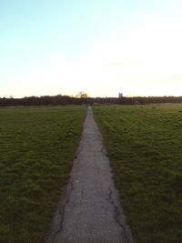 Road passing through grassy field