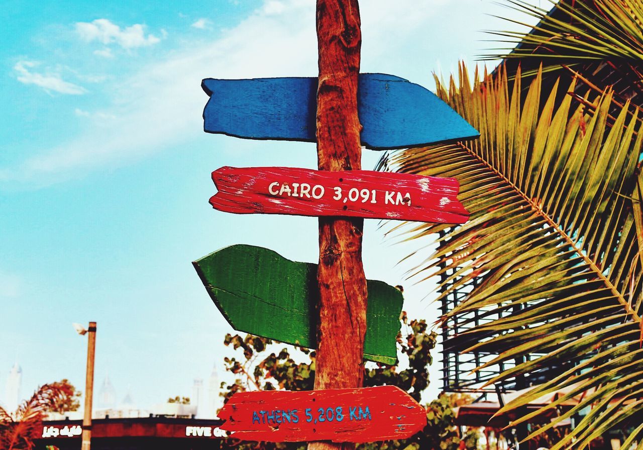 CLOSE-UP OF ROAD SIGN AGAINST SKY