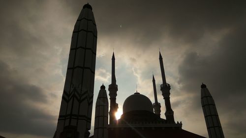 Low angle view of building against cloudy sky