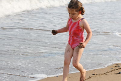 Full length of girl walking on beach