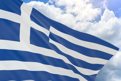 Low angle view of flag against cloudy sky