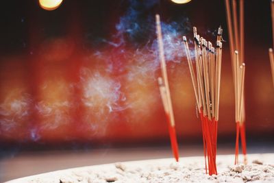 Close-up of lit candles in temple