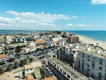 High angle view of buildings and sea against sky