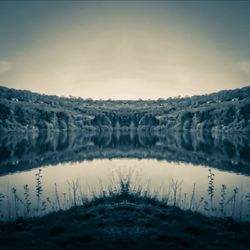 Scenic view of lake against sky during winter