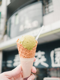 Close-up of hand holding ice cream cone