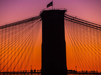 Low angle view of suspension bridge against sky during sunset
