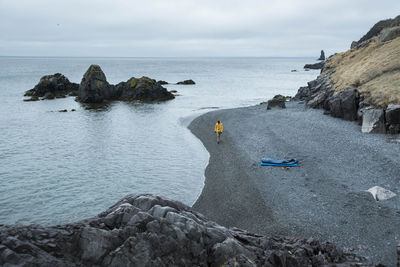 Scenic view of rocks on beach against sky