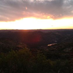 Scenic view of landscape against cloudy sky