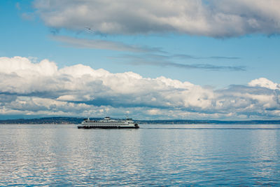 Scenic view of ferry sailing the sea against sky