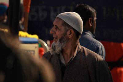 Thoughtful man wearing skull cap while walking in city