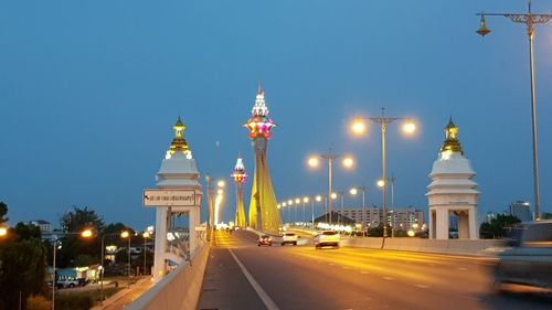 View of city street and buildings against clear sky