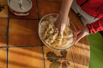 High angle view of woman preparing food on table