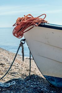 Close-up of rope tied to boat on beach