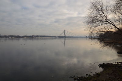 Reflection of bridge on water against sky