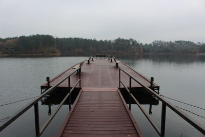 Pier on lake against clear sky