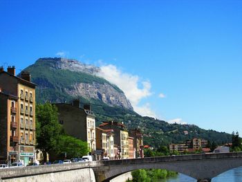 Bridge over canal against blue sky