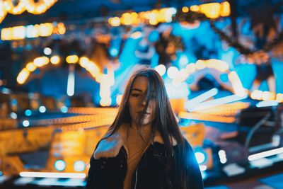 Portrait of a smiling young woman standing outdoors