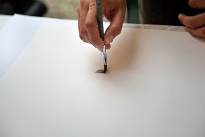 Close-up of human hand holding paper