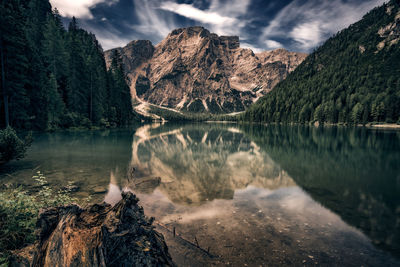 Scenic view of lake by mountains against sky