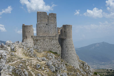 The ancient castle of rocca calascio with the beautiful mountains  of abruzzo in the background