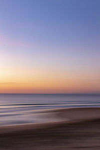 Scenic view of sea against clear sky during sunset