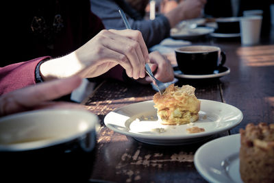 Midsection of person having food in restaurant