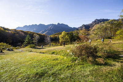 Scenic view of field and mountains against sky